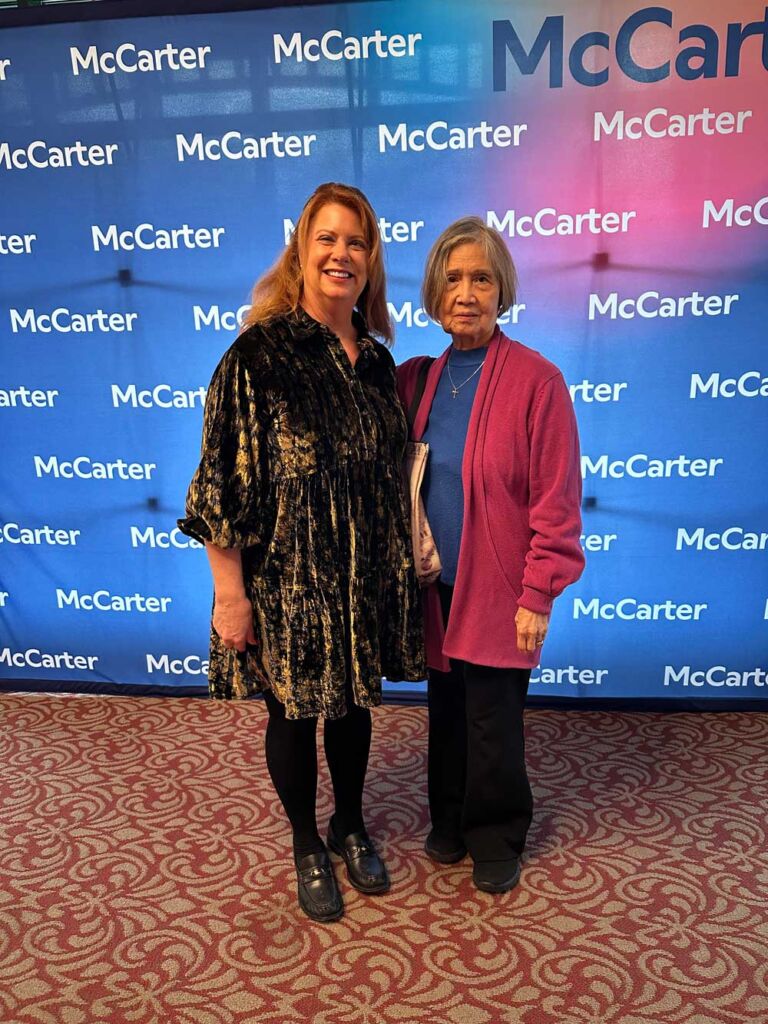two women standing in a theater lobby