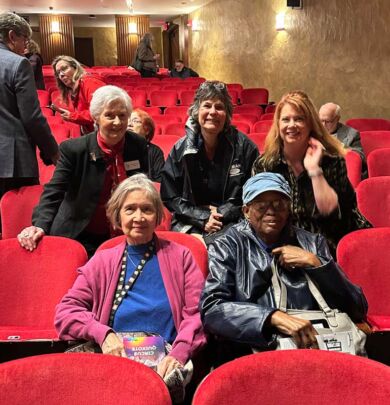 group of people sitting in theater audience
