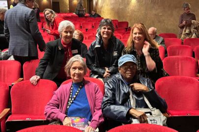 group of people sitting in theater audience
