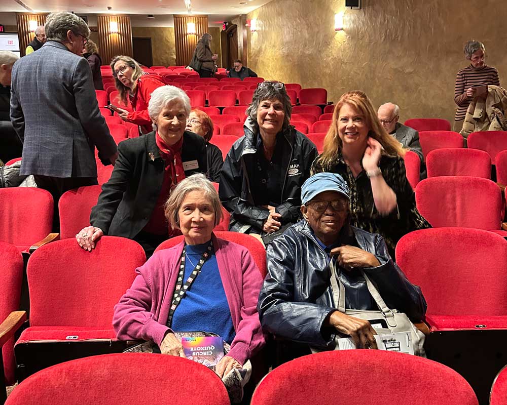 group of people sitting in theater audience
