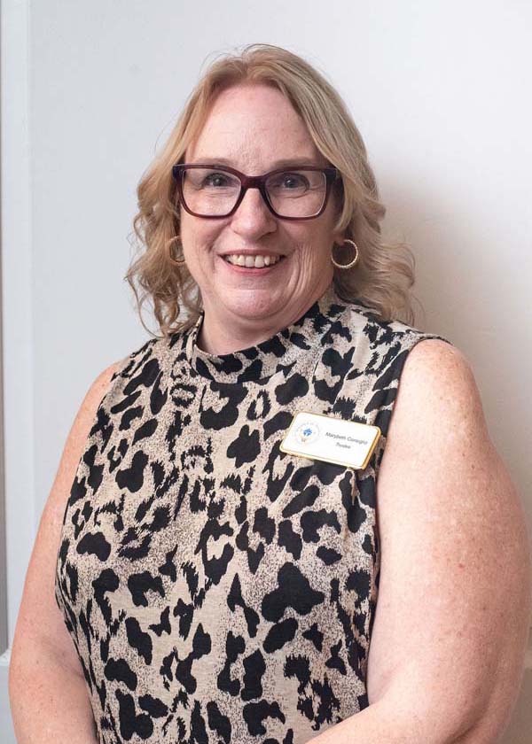 female wearing glasses and a shirt with animal print design