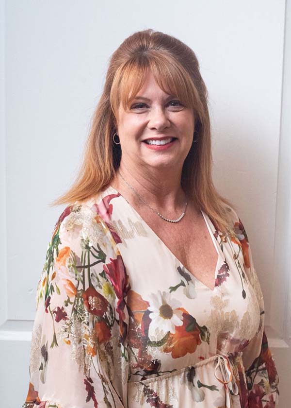 female wearing a shirt with flower design