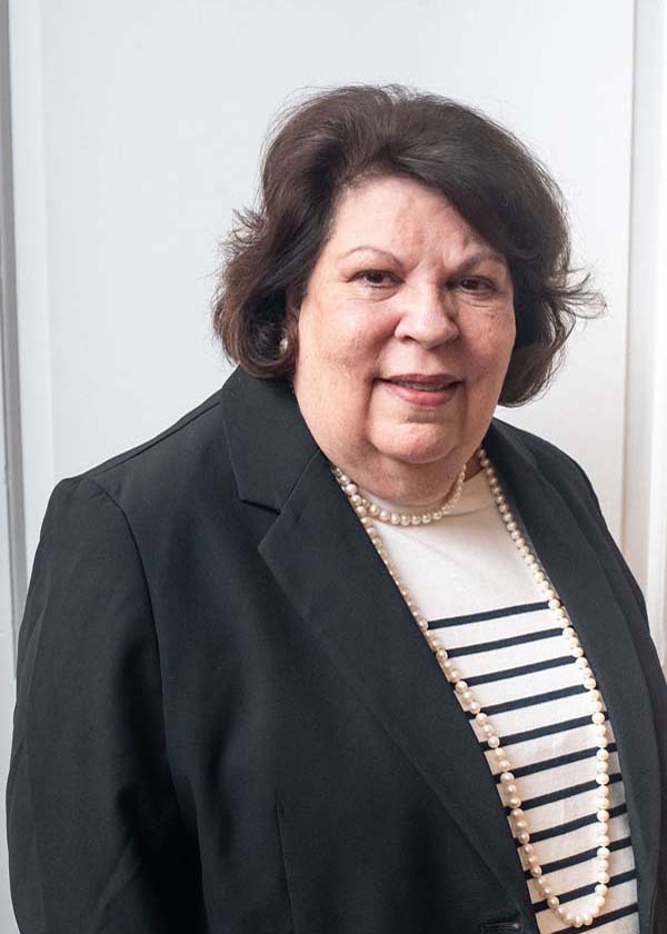 female wearing black jacket and black and white striped shirt