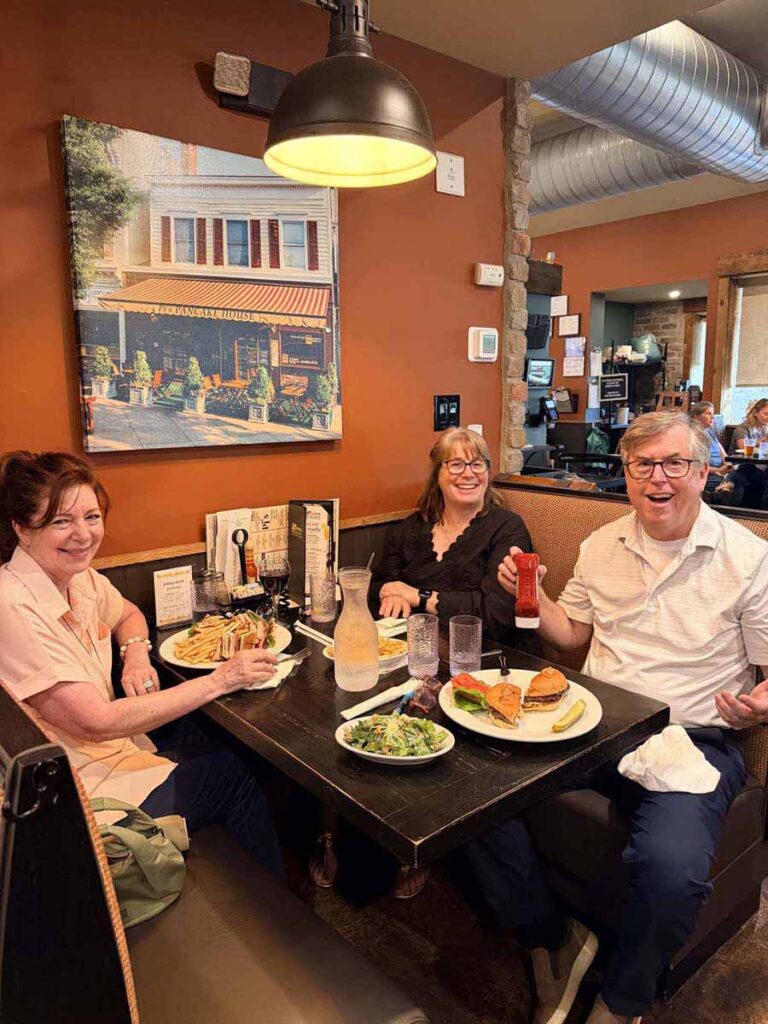 3 people sitting at a table in a restaurant