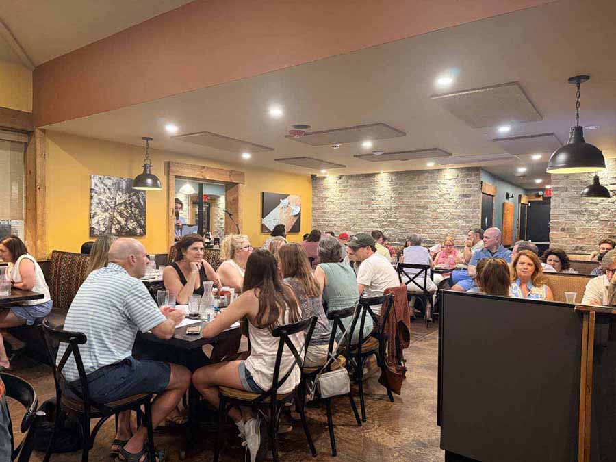 group of people sitting at a table in a restaurant